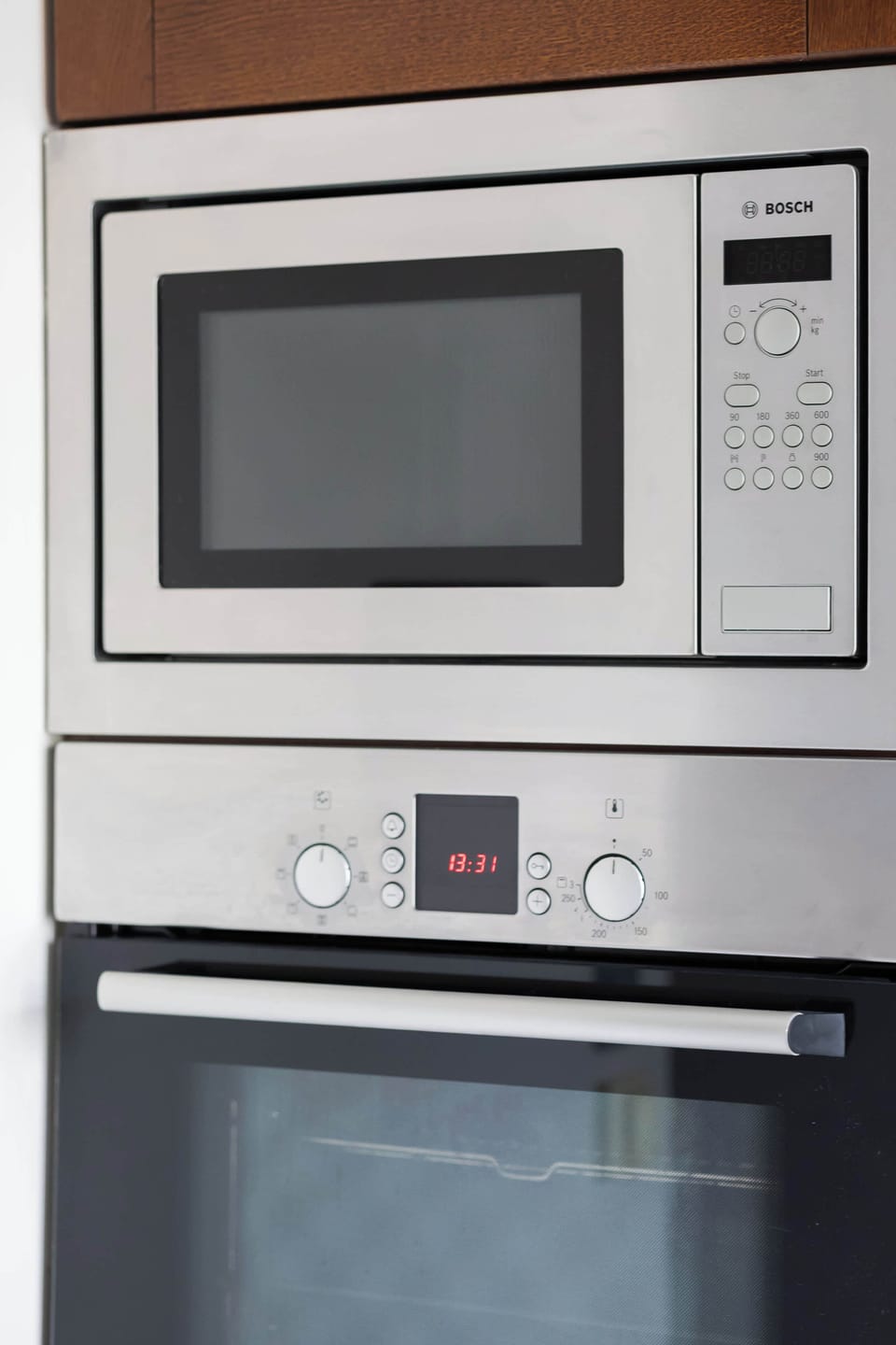 Built-in oven and microwave unit finished in stainless steel.