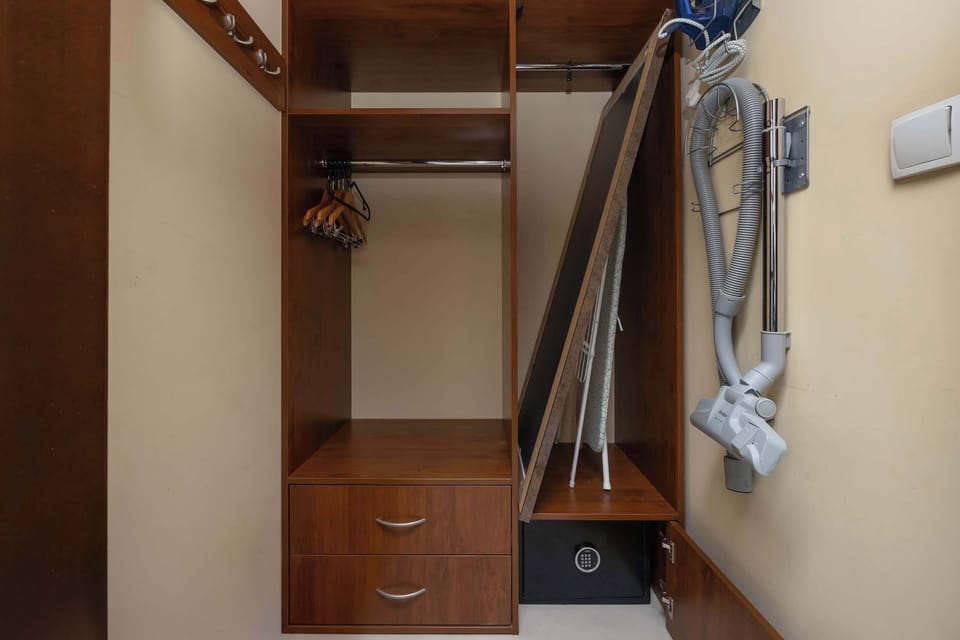 Practical wardrobe area with hanging space and shelves.