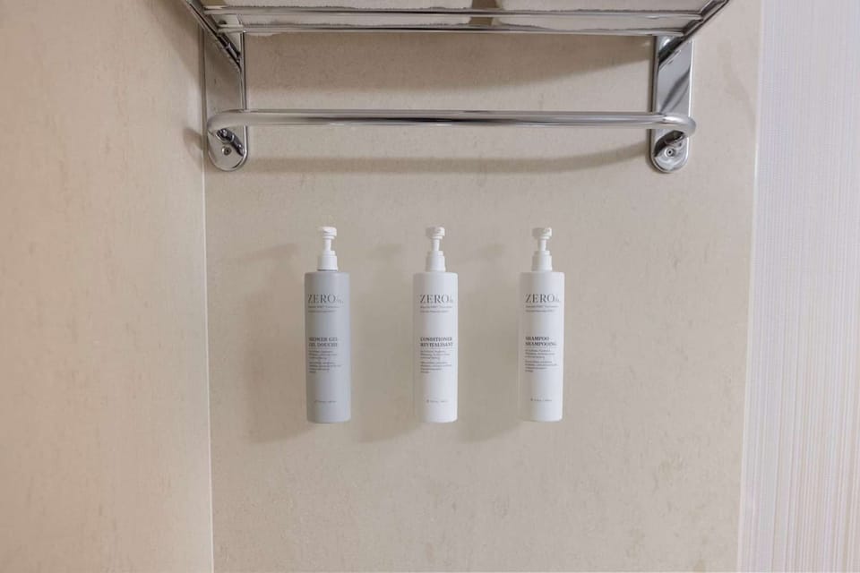Mounted shampoo, conditioner, and body wash bottles in shower