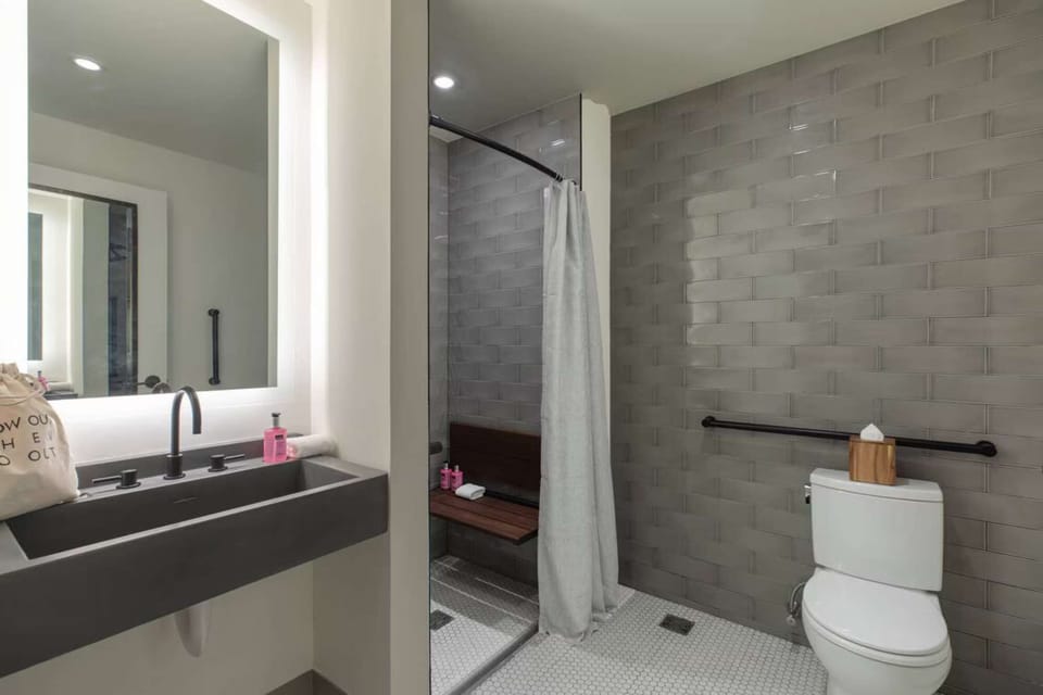 Bathroom with bench shower, curtain, and wide layout