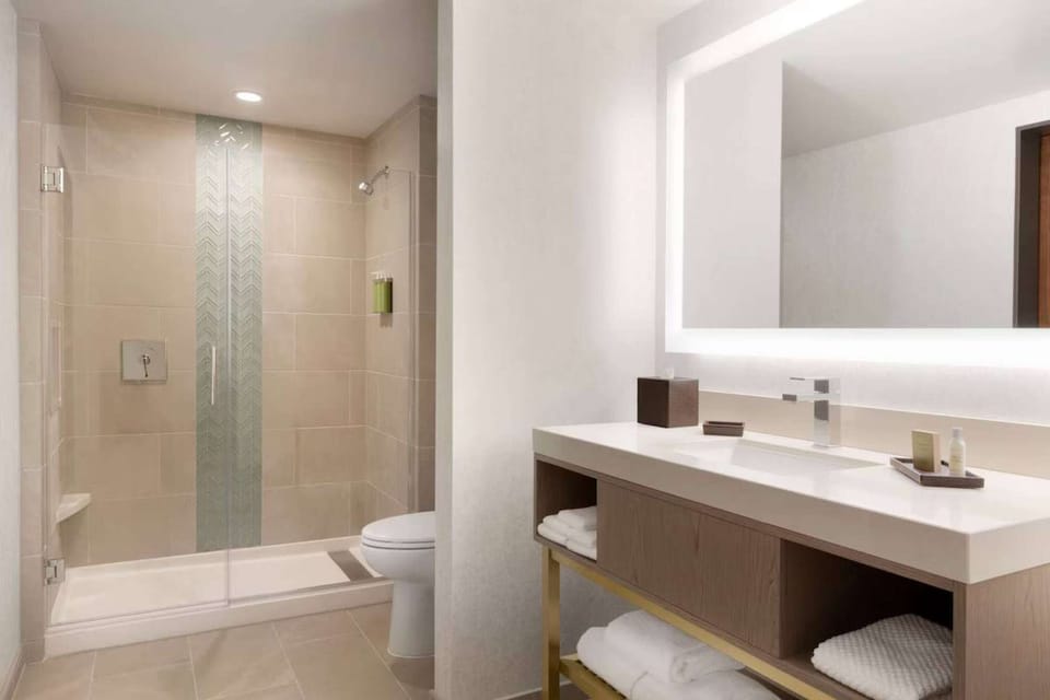 Bathroom with walk-in shower and bright mirror
