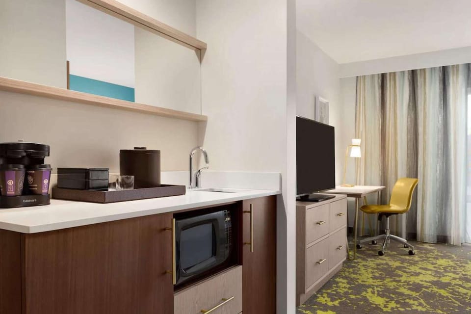 Kitchenette with sink, microwave, and coffee setup