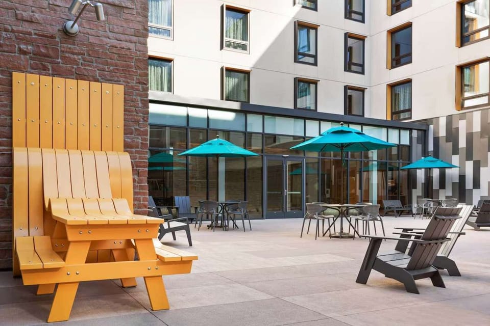 Patio seating area with bright chairs and umbrellas
