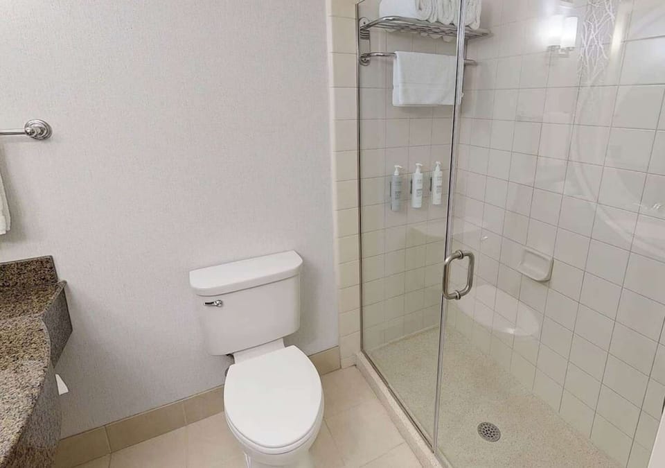 Clean bathroom with glass shower and fresh towels