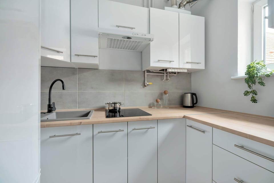 The sleek design of the kitchenette blending seamlessly with the living area.