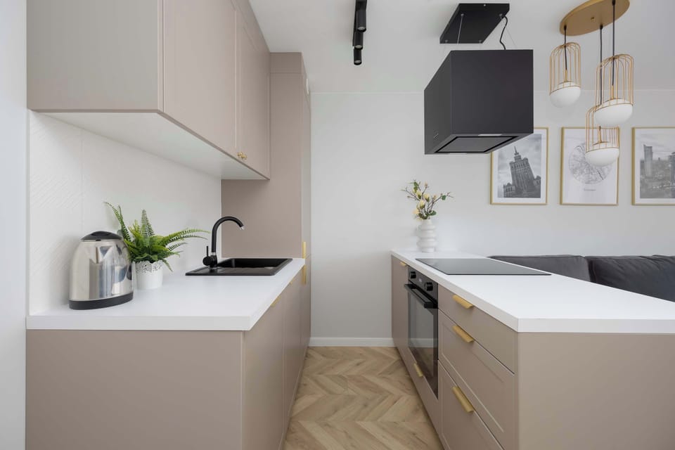 Modern kitchenette with sink, cabinets, and compact layout.