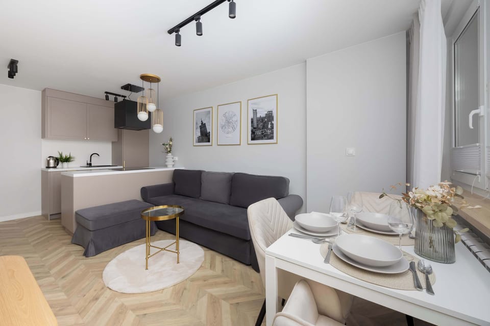 Open-plan living area with sofa and dining table.