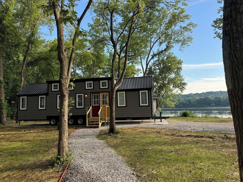Enjoy a beautiful view of the countryside and mountains just across the river of our amazing tiny home with that small cabin feel.