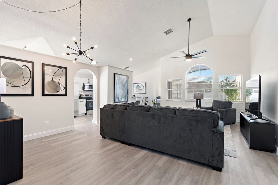 Spacious living area with sectional sofa and high ceilings