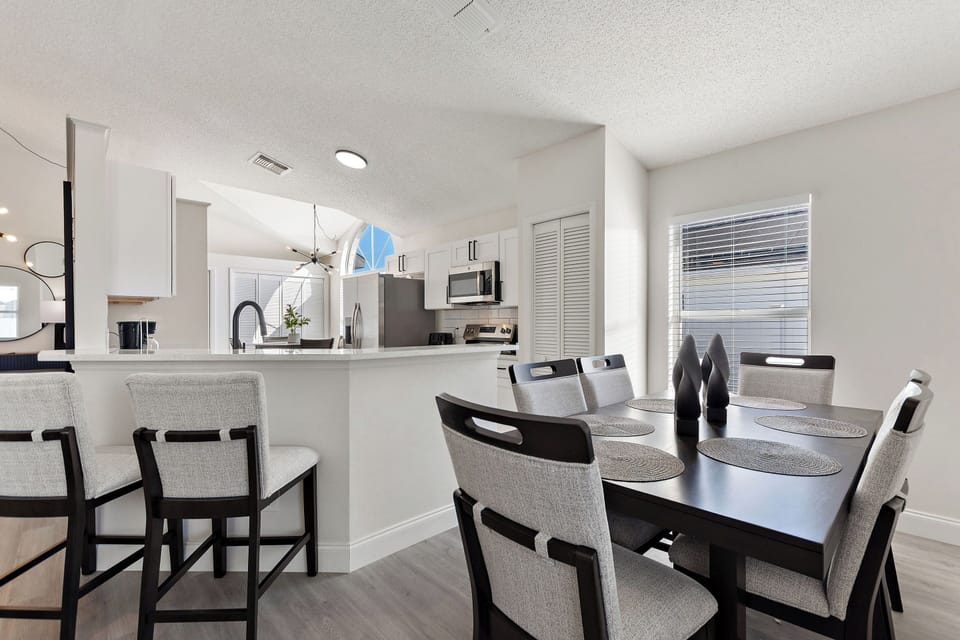 Family dining area with seating for six and view of the pool