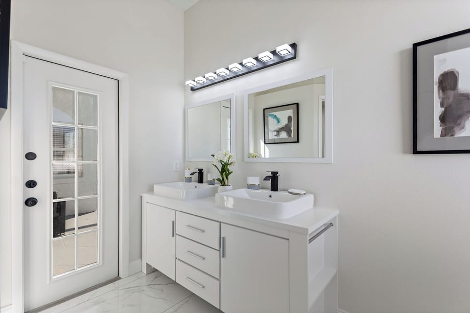 Modern full bathroom with double vanity and bright lighting