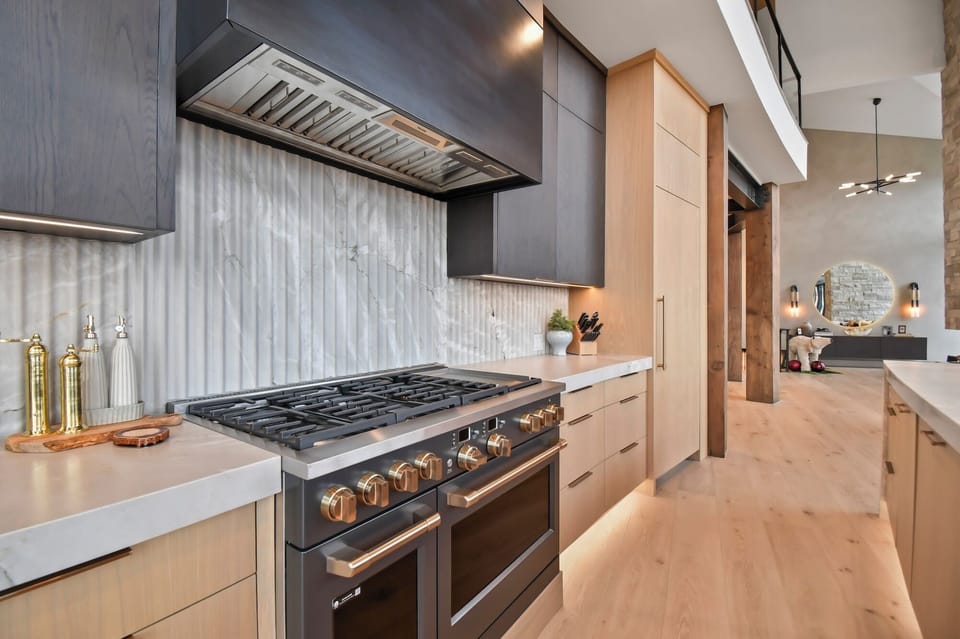 Your gourmet kitchen awaits with professional-grade appliances and elegant marble backsplash for memorable meal preparation.