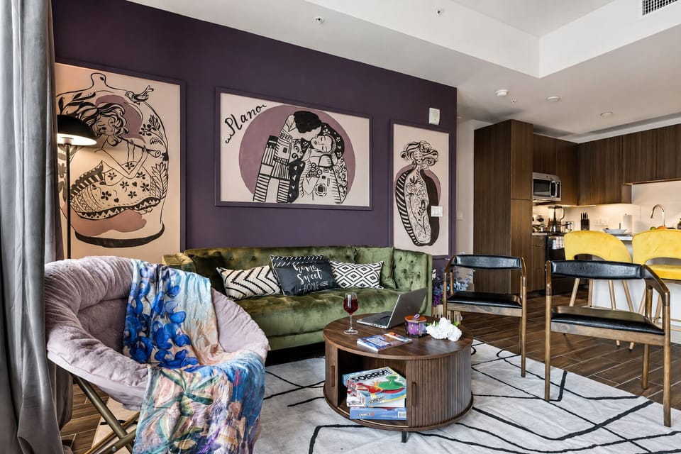 Art-filled modern lounge with velvet sofa and chic open kitchen