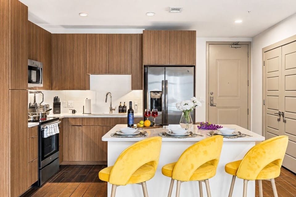 Modern kitchen with island seating, stainless appliances, and chic decor