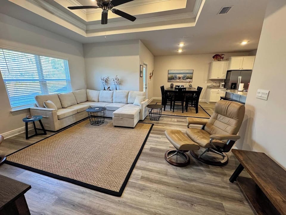Open‑concept living room with plush seating and a large Smart TV — perfect for movie nights.