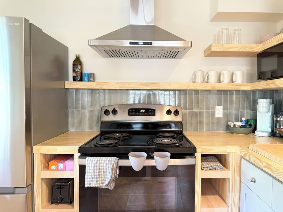 Brand new build kitchen, with toaster, kettle, coffee bar, and microwave. 