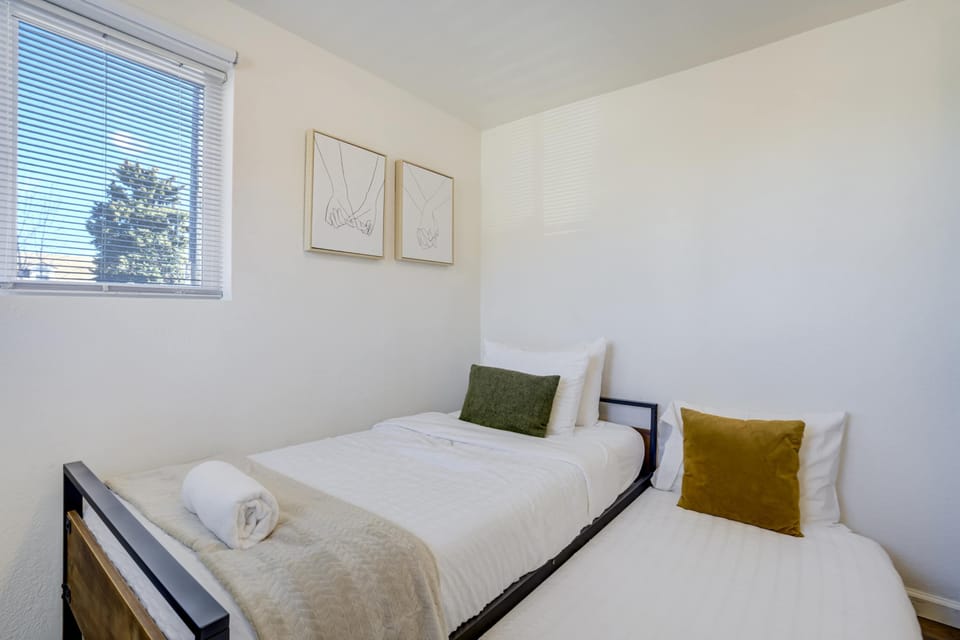 Every corner of this home is designed for functionality and relaxation. This sunlit sleeping space offers a quiet sanctuary just minutes away from the vibrant energy of downtown Colorado Springs and Memorial Park.