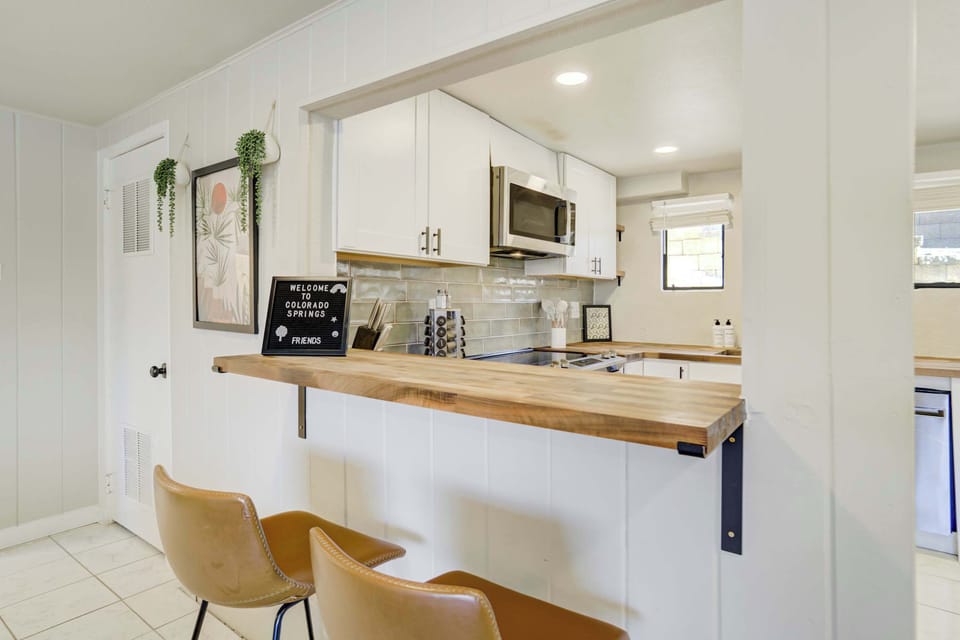 Kitchen bar with counter seating that opens into the main living space, ideal for casual meals or morning coffee.