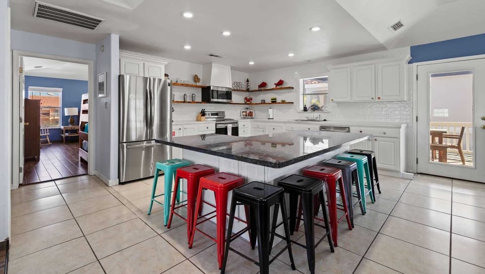 Full kitchen with a large island and seating for the crowd