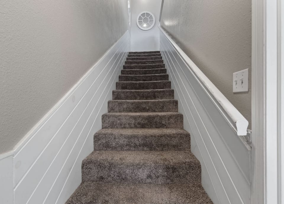 Stairs connect the upstairs living and downstairs game room