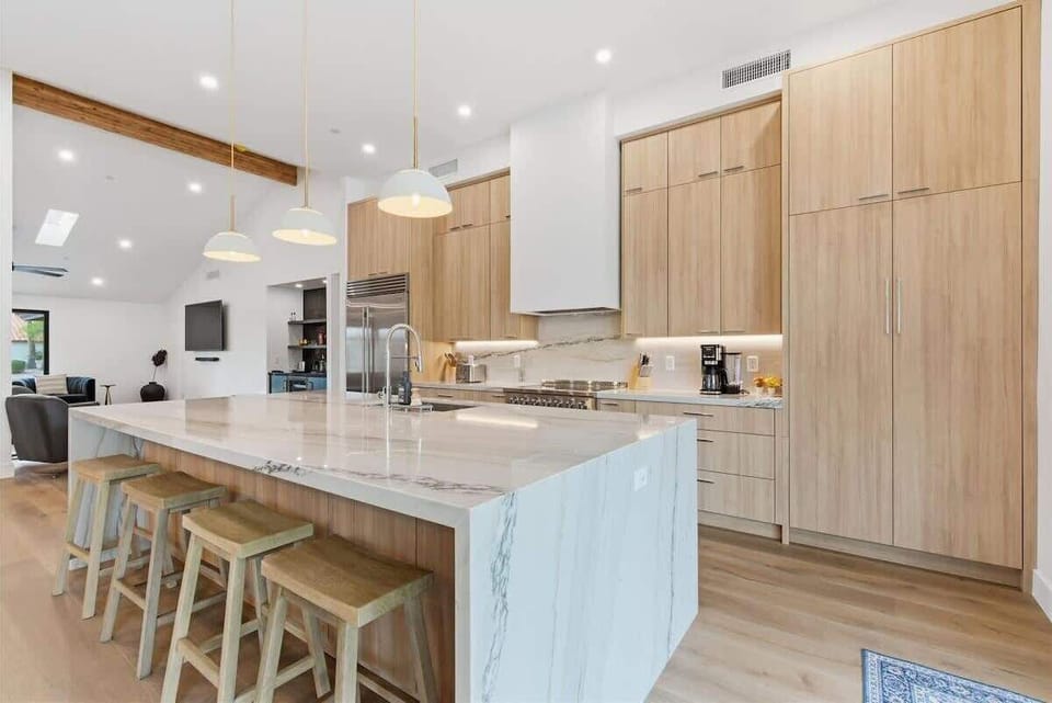 Fully equipped kitchen with stainless steal appliances and a kitchen island with bar seating for 4 guests.