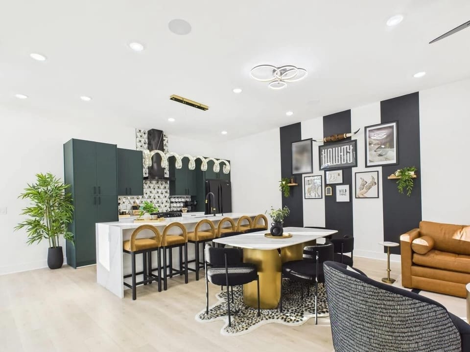 2nd Floor: Dining area featuring a marble and gold table paired with black chairs, offering seating for 6 guests.