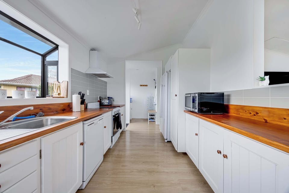 The kitchen has everything you need including a dishwasher, microwave, oven and fridge.