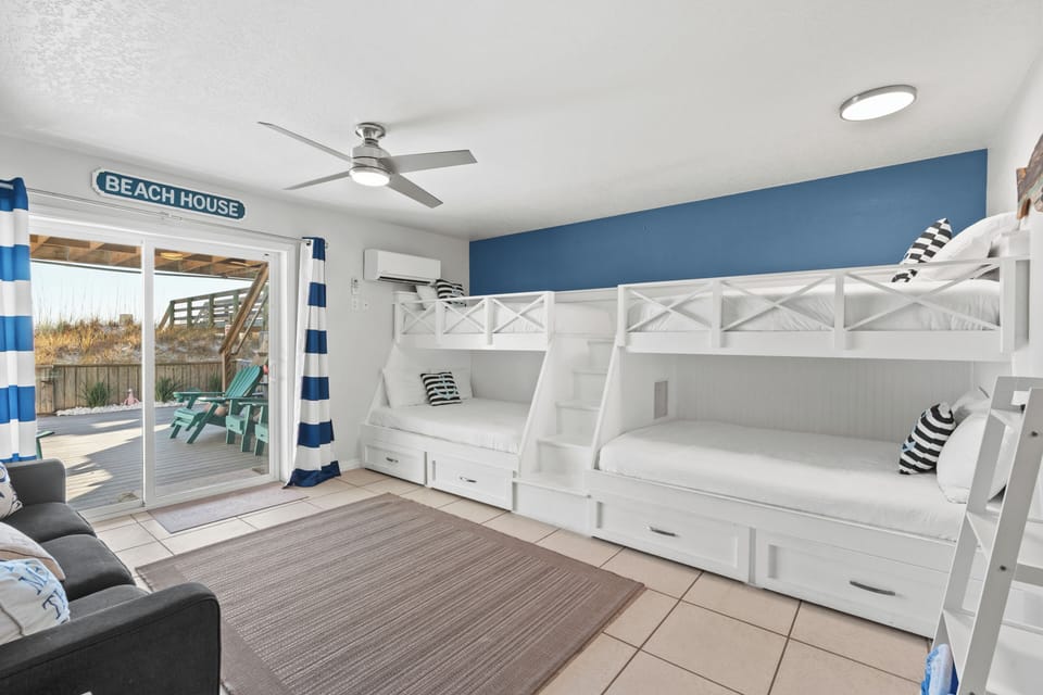 Bunk room with sliding glass door access to the outdoor deck.