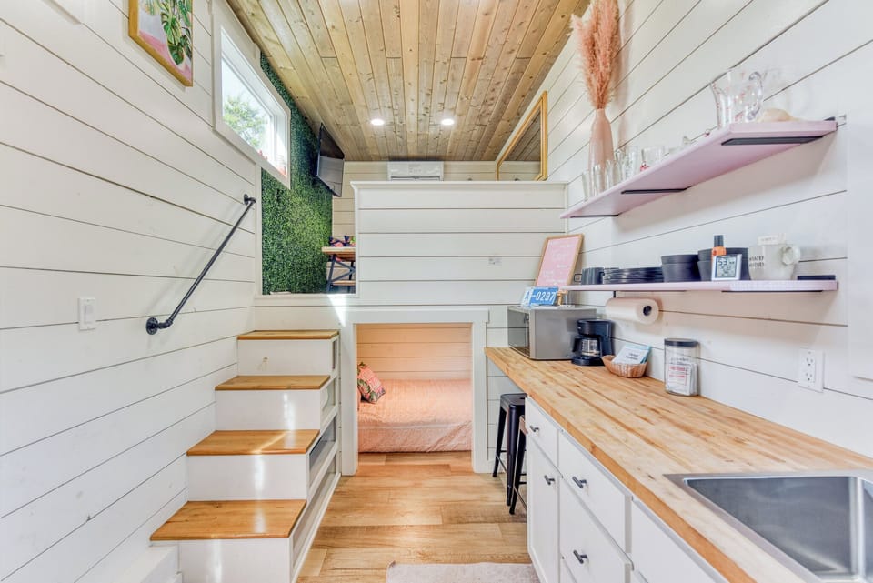 At the left end of the home is the living room and bedroom one