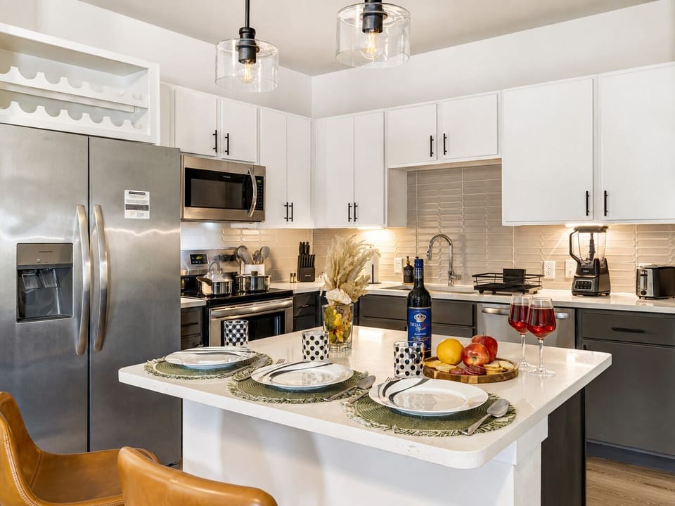 Bright modern kitchen with island dining and stainless steel appliances