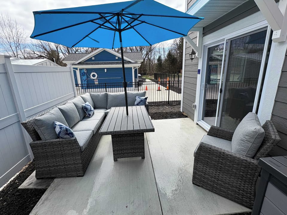 Comfortable outdoor space with grill and view of the clubhouse and pool!