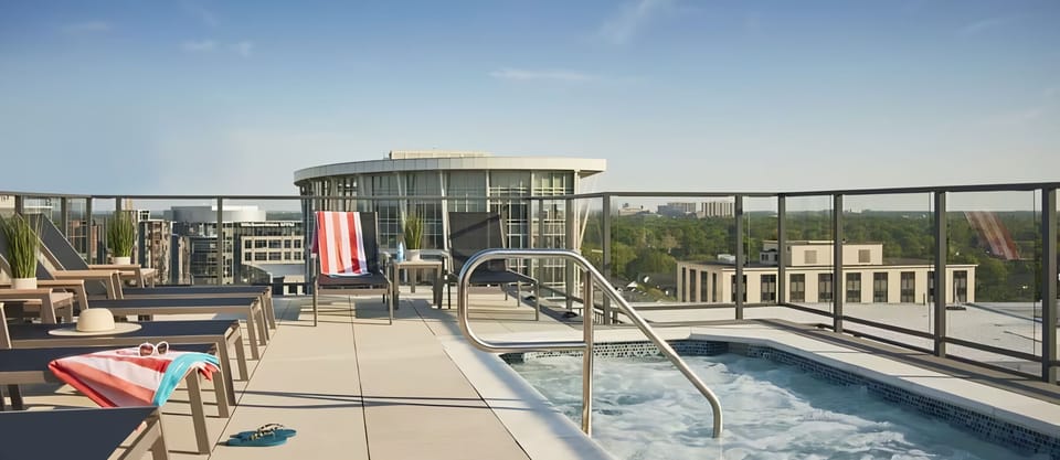 Unwind in the bubbling rooftop hot tub with skyline views.