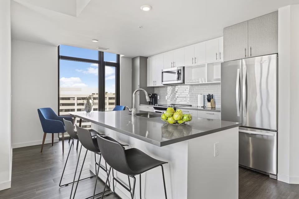 Gather for breakfast around the sleek island and city light.