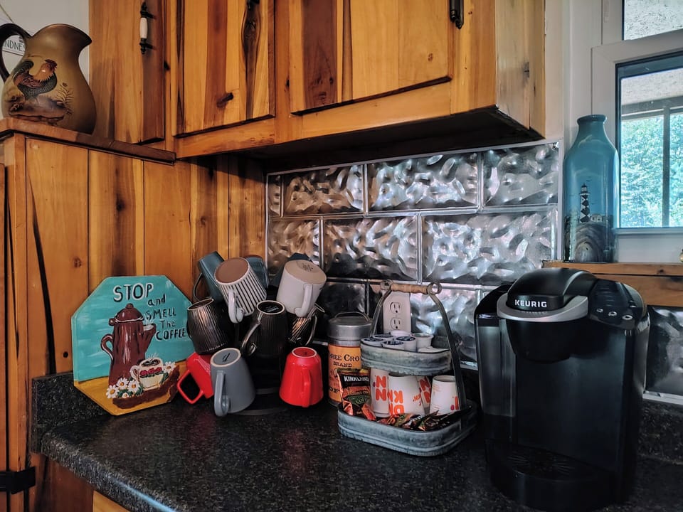 coffee station with pods and a full pot coffee maker available in the kitchen