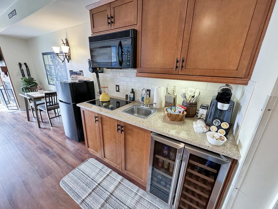 Cozy kitchen nook with wine fridge and warm wood cabinetry