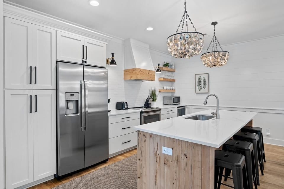 Modern kitchen with spacious island and stylish lighting