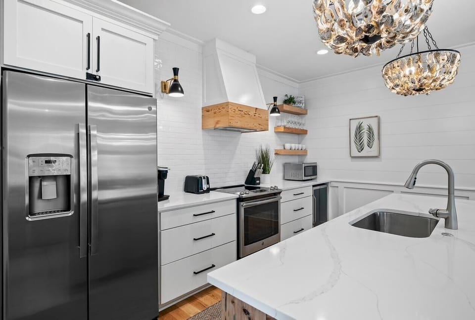 Modern kitchen with sleek appliances and elegant lighting