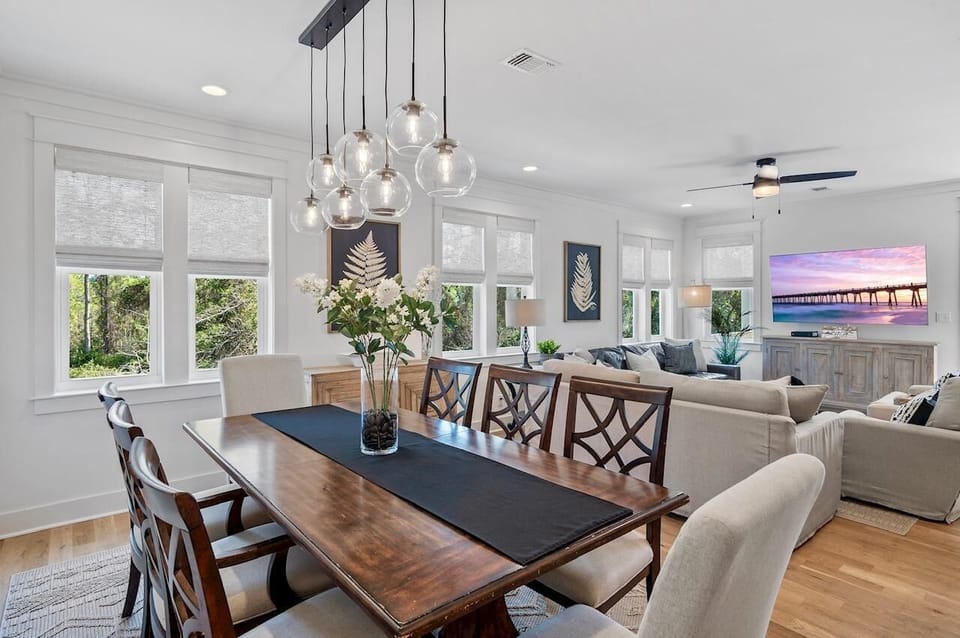 Bright open dining and living area with scenic views