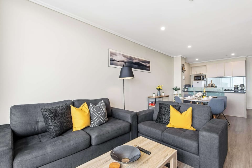 Relax on the comfortable designer sofa, perfectly positioned for movie nights or city gazing.