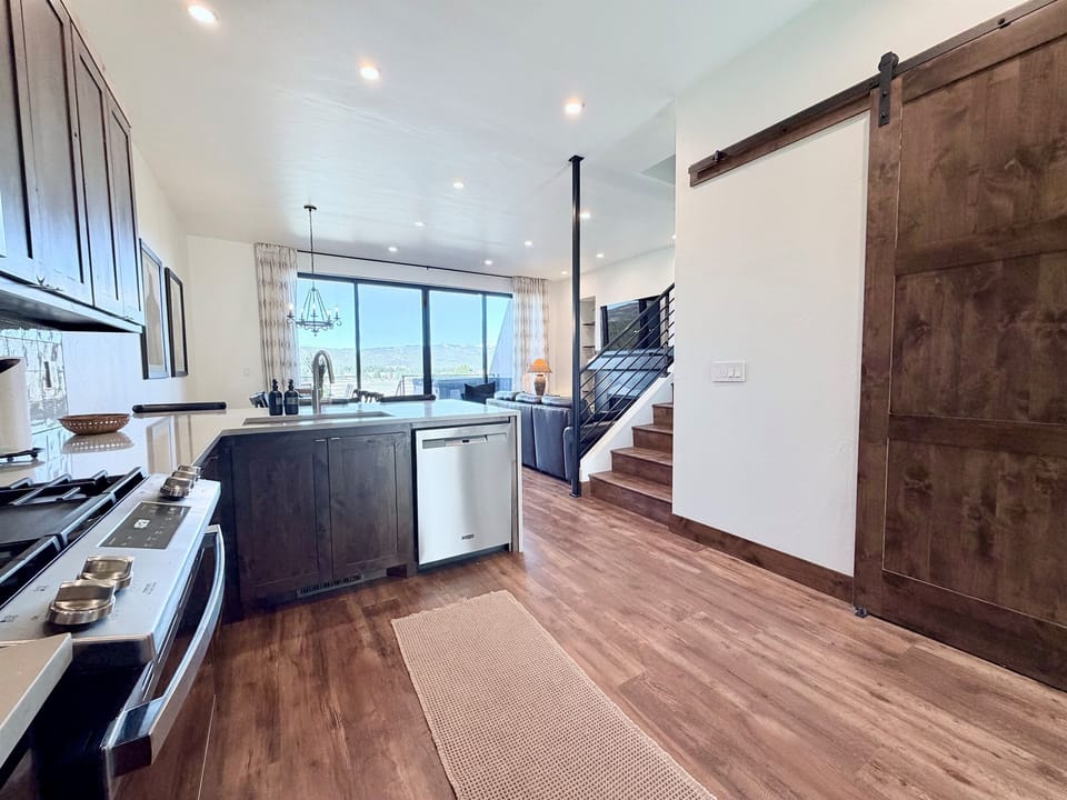 2) Spacious kitchen with open layout, large island, and seamless flow to the main living area—ideal for cooking and gathering.
