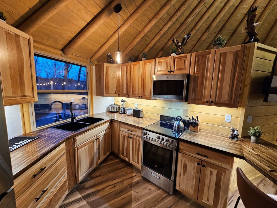 Additional kitchen view with generous counter space and forest views