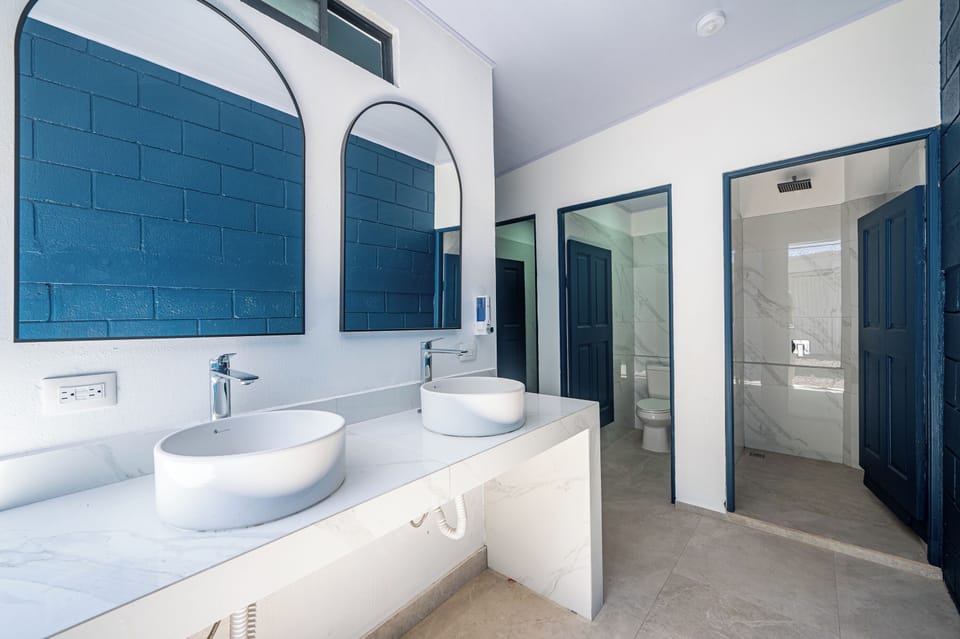 Cylindrical Room with Shared Bathroom | Bathroom | Shower, towels, soap, shampoo