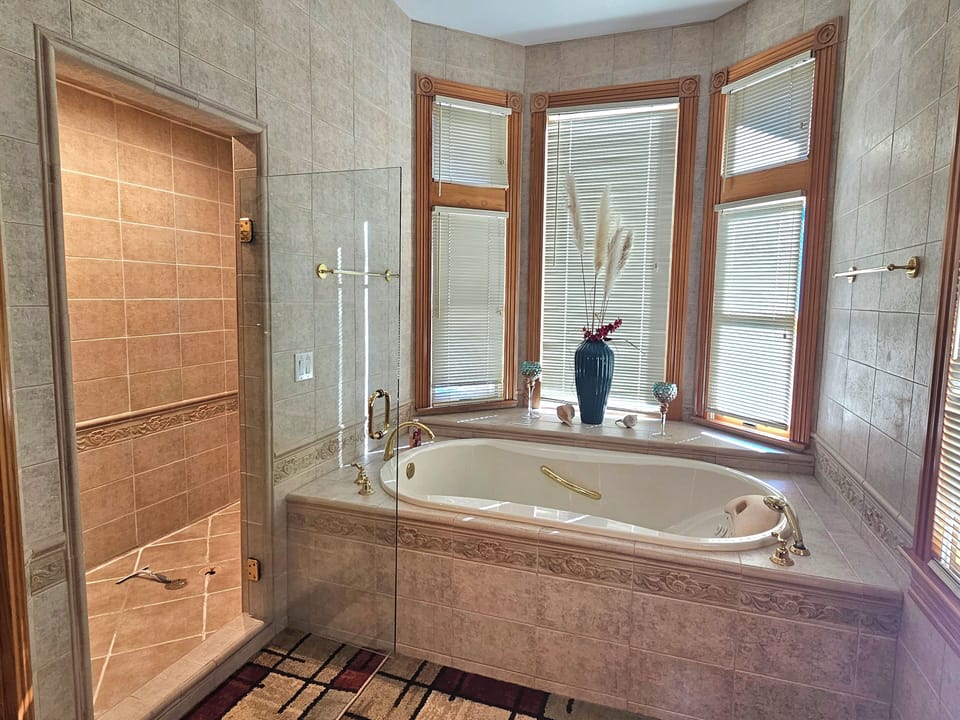 Main level master bath with double walk in shower, double vanity, soaking tub