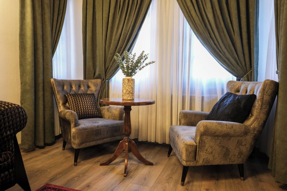 Luxury Room | Living area | 34-inch LCD TV with satellite channels, heated floors