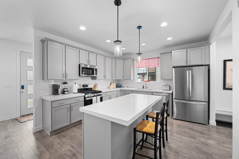 Large kitchen island with additional seating in a well appointed Chefs Kitchen