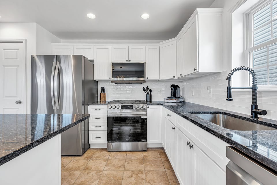 Fully stocked kitchen w/ gas stove, microwave, dishwasher, coffee maker