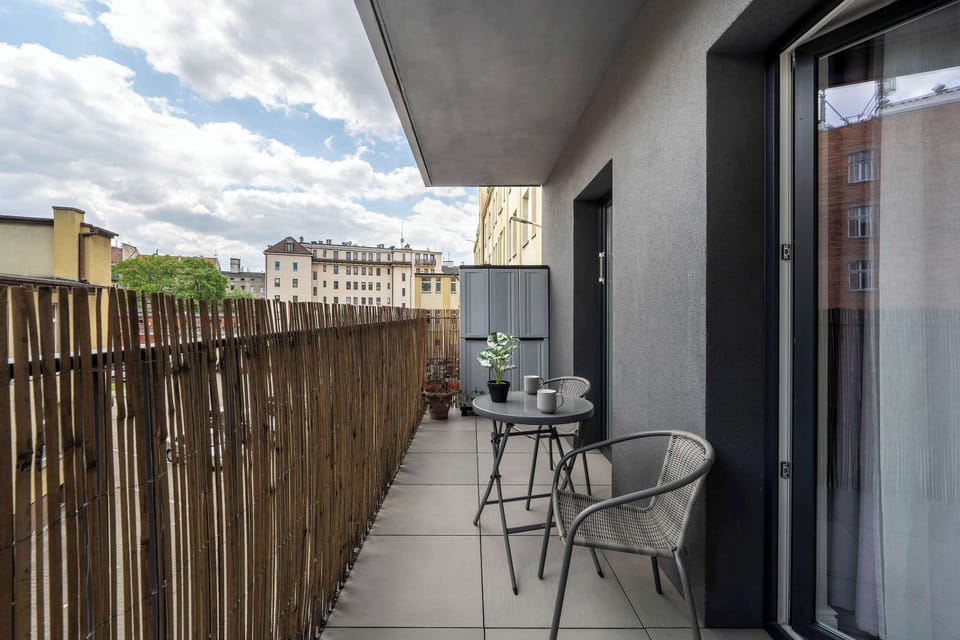 The balcony with a bamboo screen offers privacy and a pleasant spot for outdoor relaxation.
