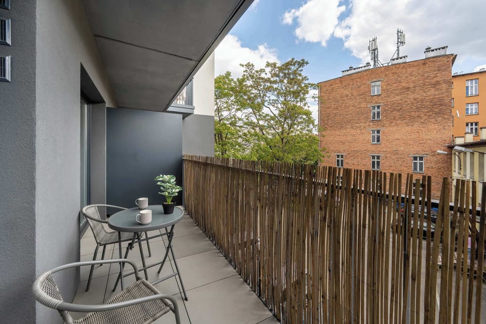 A private balcony with a green view makes the perfect spot for morning coffee.