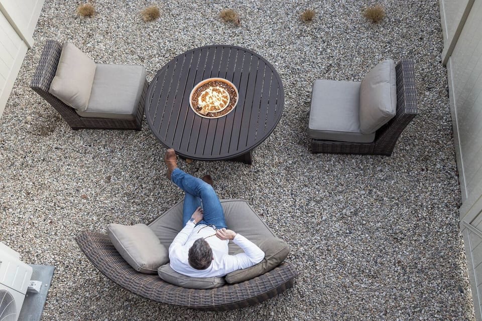 View of Backyard, fire pit and outdoor furniture from the second floor patio.