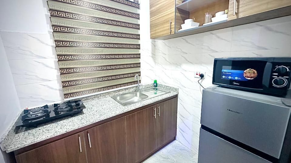 Apartment | Private kitchen | Fridge, microwave, stovetop, cookware/dishes/utensils